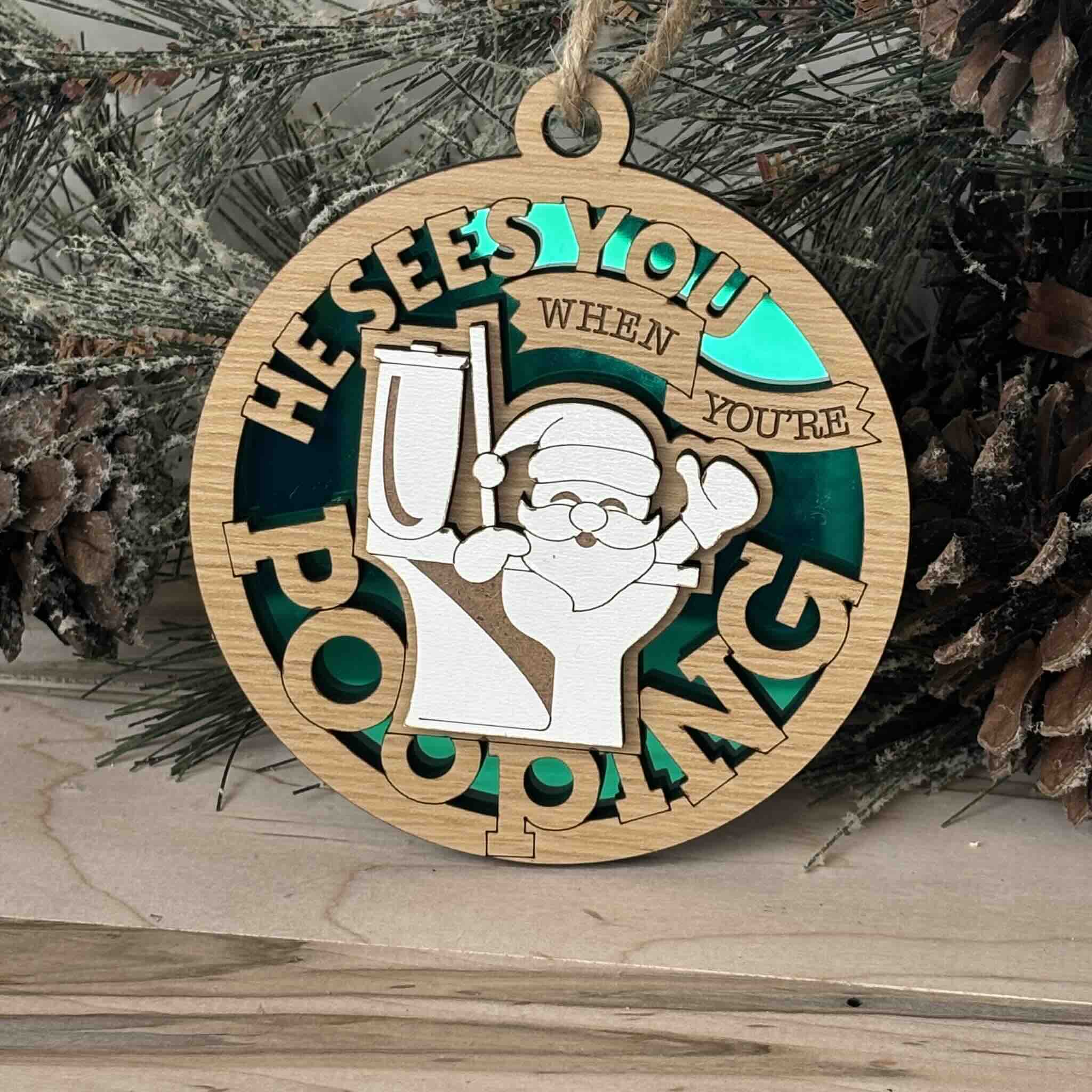 Funny Santa ornament with the phrase 'He sees you when you're pooping'