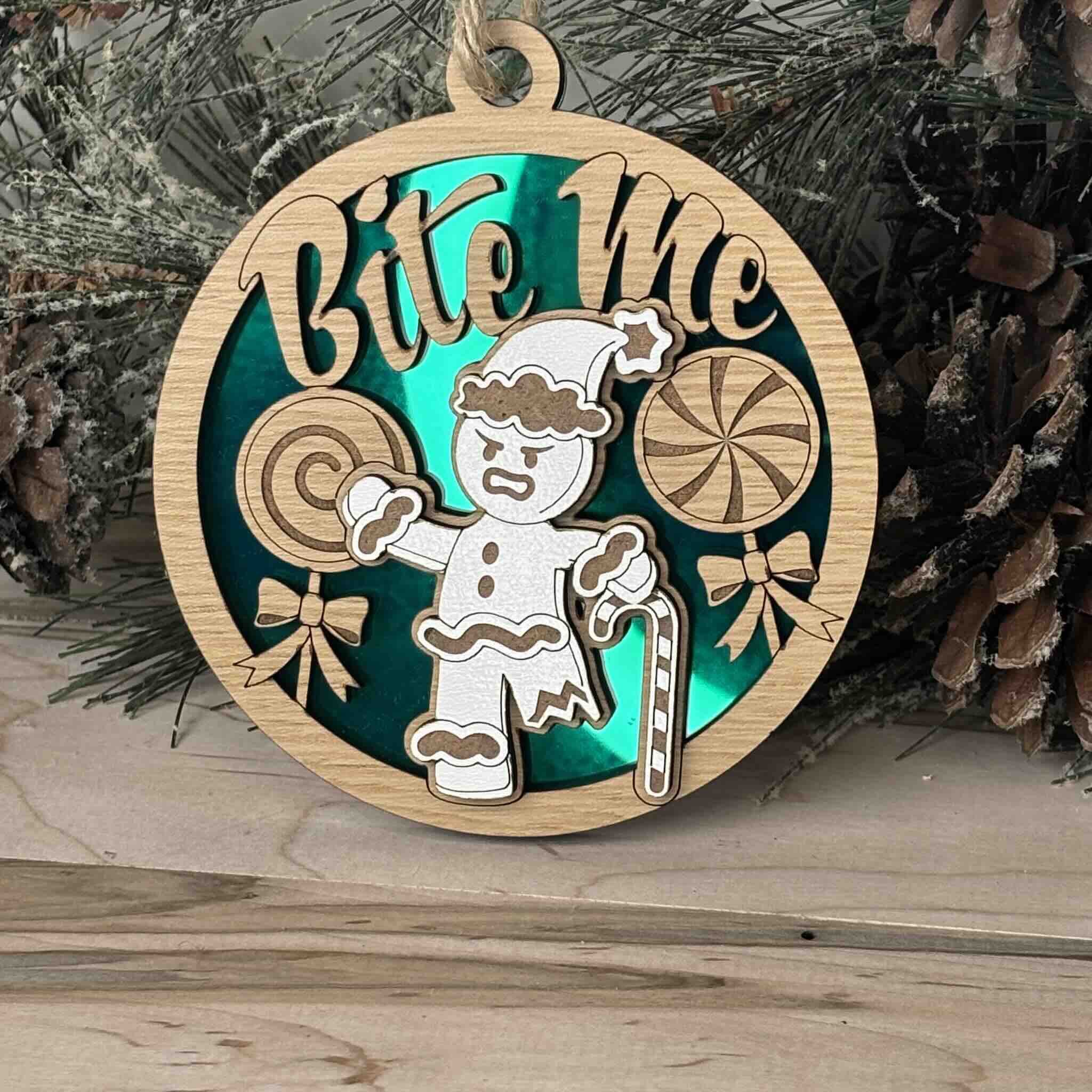 Round wooden ornament with 'Bite Me' message and gingerbread design