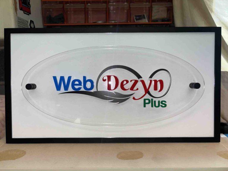 Web Dezyn Plus logo on an oval glass panel