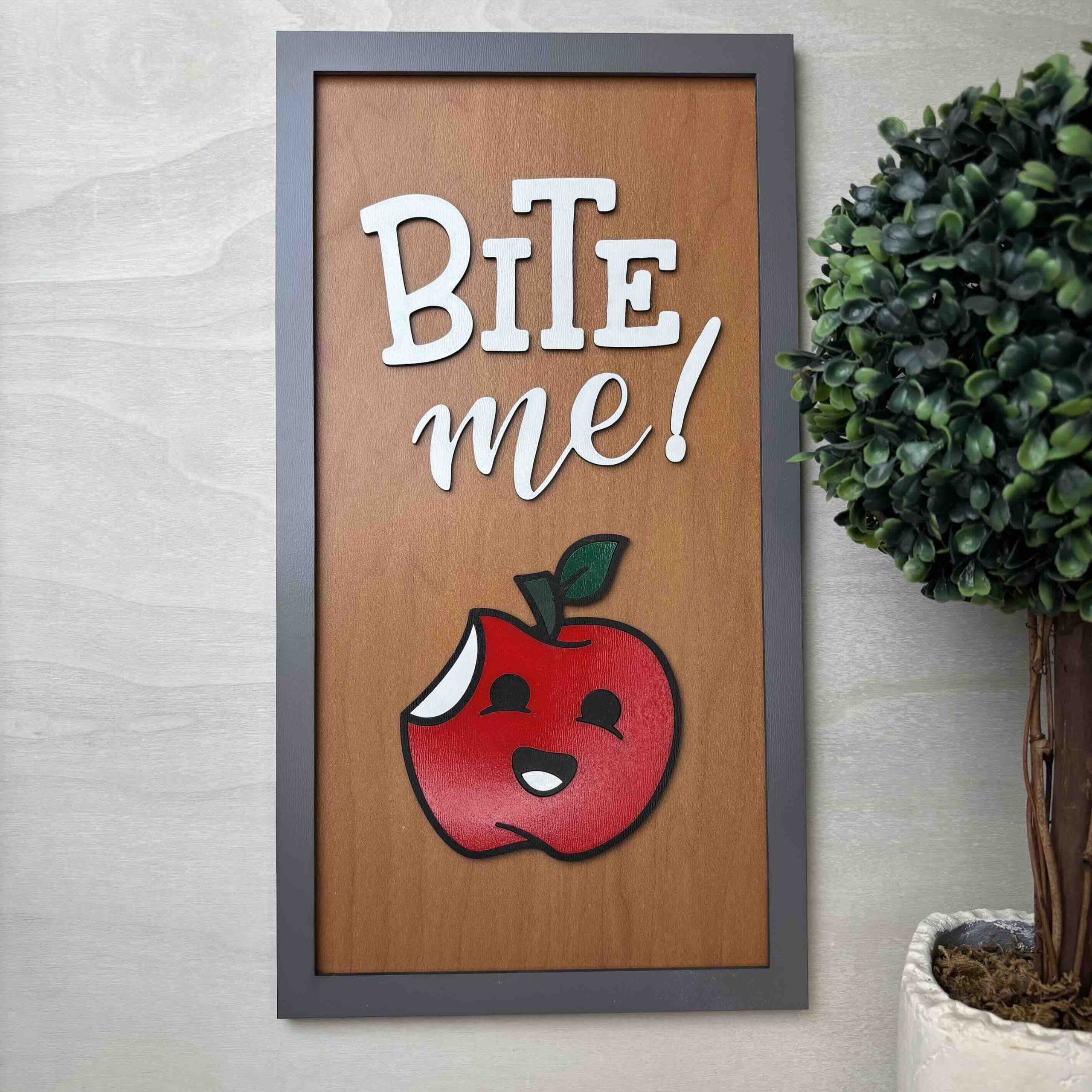 Humorous apple wall art with 'Bite Me' phrase