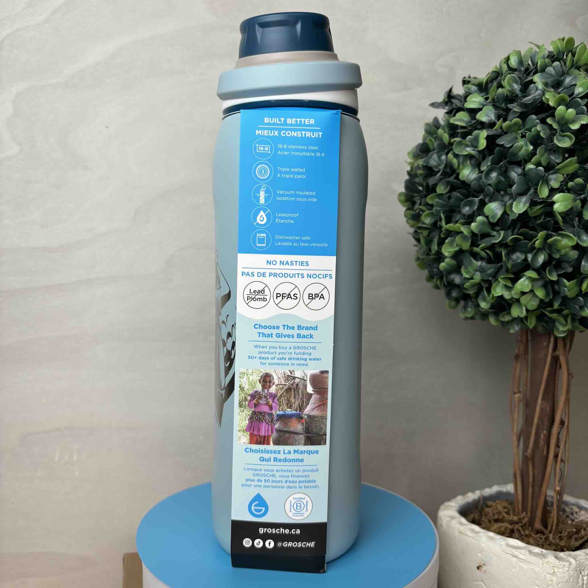 Insulated water bottle with 'Built Better' label and environmental impact icons