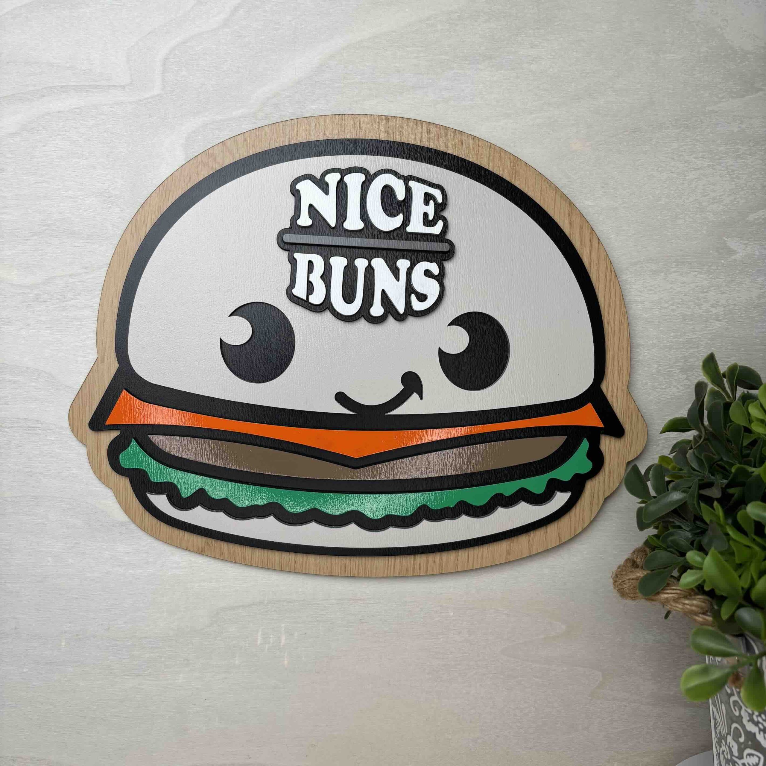 A playful sign featuring a cartoon burger character with the phrase 'Nice Buns'