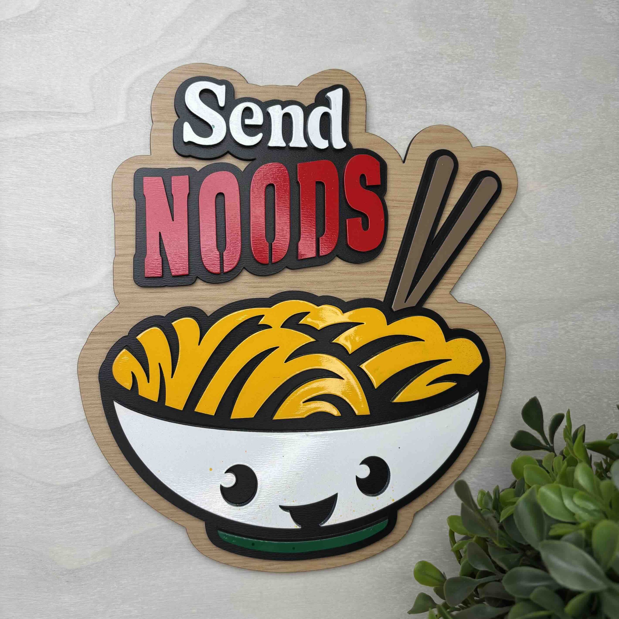 Humorous wall art with bowl of noodles and 'Send Noods' text