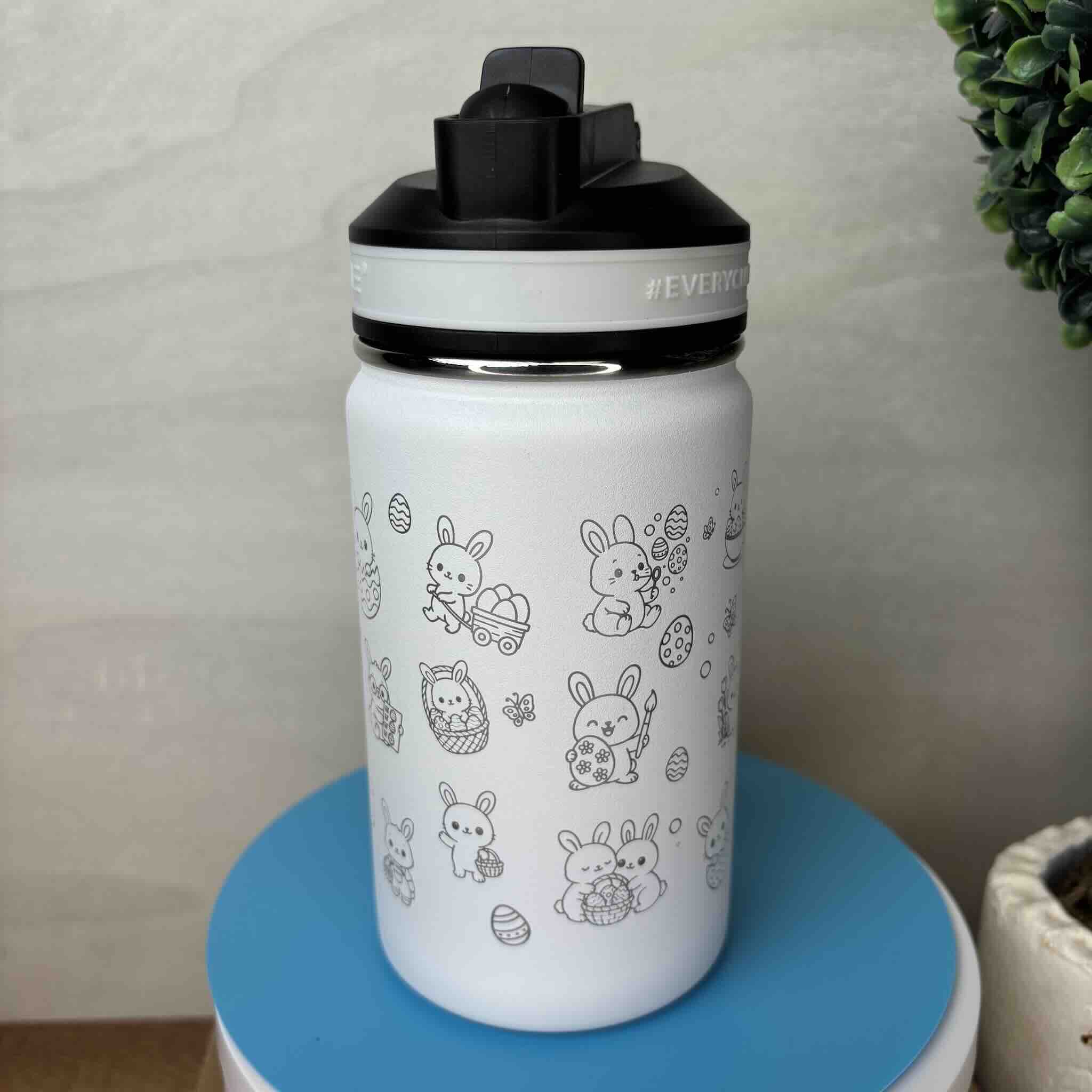 White water bottle with cute animal illustrations and black lid